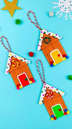 three gingerbread house ornaments on a blue background