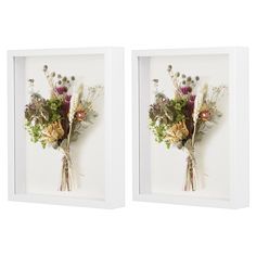 two white framed pictures with flowers in them