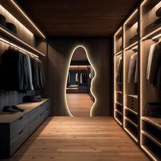 a walk in closet with wooden flooring and illuminated lighting on the walls, along with clothes racks