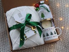 an open box containing two mugs, a tea cup and a christmas ornament