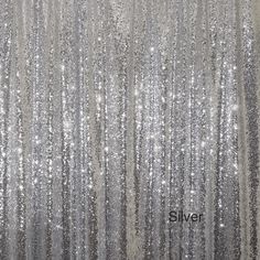 silver sequin curtains are hanging in front of a white wall with the word silver on it