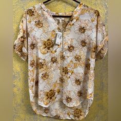 Medium. Yellow, Light Pink, White, And Brown Floral. Brand New With Tags. Yellow Summer Printed Blouse, Yellow Printed Summer Blouse, Yellow Floral Print V-neck Blouse, Casual Mustard V-neck Blouse, Yellow V-neck Blouse With Floral Print, Gold Summer Workwear Top, Gold Summer Top For Workwear, Yellow Printed Blouse For Day Out, Gold V-neck Summer Blouse