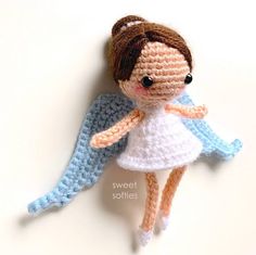 a crocheted doll with an angel on it's back