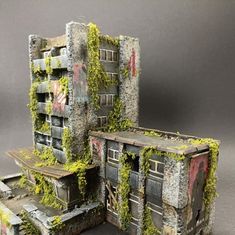 an old building with moss growing out of it's sides and doors on the outside