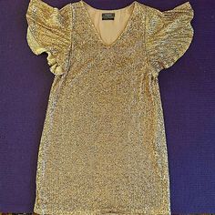 Beautiful, Golden, Never Worn, Gold Sequin Dress. Very Flattering And Fun. It Sits Right On The Knee To Someone Who’s 5.7 Great Party Dress! Flutter Sleeve Mini Dress For Party, Elegant Holiday Dresses For Brunch, Chic Flutter Sleeve Dress For Party, Chic Flutter Sleeve Party Dress, Festive Chic Ruffled Dresses, Elegant Flutter Sleeve Mini Dress For Night Out, Chic Festive V-neck Dresses, Gold Ruffled Dress For Night Out, Elegant Short Sleeve Mini Dress For Festive Occasions