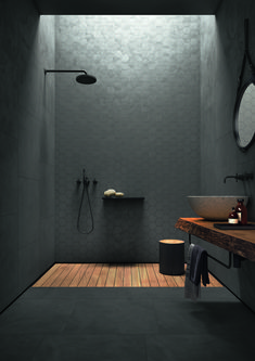 a bathroom with a wooden floor and white walls, along with an open shower stall