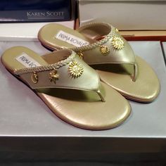 Size 6m Gold Color With Gold-Tone Charms New With Box Gold Slippers For Summer, Gold Toe Post Flip Flops For Vacation, Gold Summer Slippers, Gold Slip-on Flip Flops For Summer, Adjustable Gold Open Toe Flip Flops, Gold Slip-on Flip Flops For Spring, Gold Flat T-strap Sandals For Beach, Dressy Wedges, Memory Foam Sandals