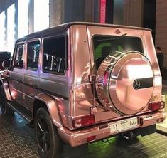 a mercedes g - class parked in front of a building