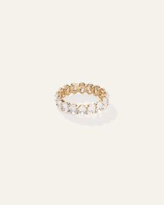 a gold ring with white stones