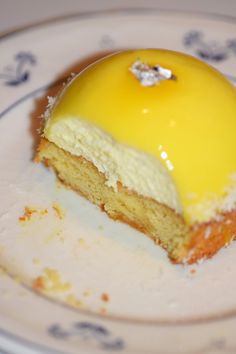 a piece of cake sitting on top of a white and blue plate covered in icing