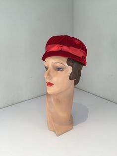 "Circa:  Late 1950s Early 1960s PinkTucked Quilt of Red velvet pill box hat, small brim to boot, with an added dash of Red satin band and bow. Wear this beauty on the back of the head or straight. Beautiful Candy Apple Red velvet colour. 22\" circumference.   DO YOU ACCEPT OFFERS? We do NOT accept offers or negotiate on pricing. We do offer layaways and have sales throughout the year. Shipping overages are always refunded. Label:  Unmarked Fabric: rayon velvet, grosgrain, rayon satin Condition: Retro Red Party Hat, Red Retro Party Hat, Red Vintage Mini Hats With Curved Brim, Vintage Red Party Hat, Retro Cloche Mini Hat For Formal Occasions, Retro Cloche Mini Hat For Formal Events, Retro Formal Cloche Mini Hat, Retro Mini Hats For Vintage Events, Vintage Red Adjustable Mini Hats