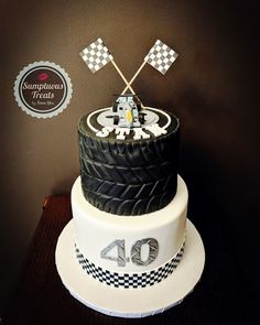 a birthday cake made to look like a racing car on top of a race track