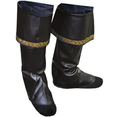 a pair of black leather boots with gold chains on the side and one foot in the middle