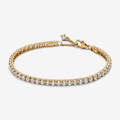 Choose a modern spin on a classic style with the Sparkling Tennis Bracelet. This 14k gold-plated bracelet sparkles with 48 round prong-set stones. Adjustable and dynamic, this cubic zirconia tennis bracelet features one sparkling stone dangling from beside the clasp for the perfect finishing touch. Designed with slightly larger stones than our other tennis bracelet styles, this bracelet is perfect for making a fresh statement when stacked with other bracelets in mixed tones and styles. - Pandora Sparkling Tennis Bracelet - 14k Gold-plated unique metal blend / Cubic Zirconia / Clear - Sz. 7.9 in Bracelet Styles, Xmas Wishlist, Bracelet Tennis, Mum Birthday, Birthday List, Gold Plated Bracelets, Lab Created Diamonds, Tennis Bracelet, Bracelet Sizes