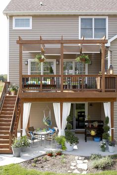 a deck with curtains on the side of it