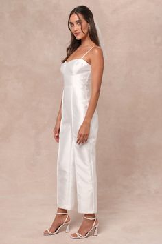 Get ready to become an overnight style icon in the Lulus Contemporary Pose White Taffeta Bustier Sleeveless Jumpsuit! Crisp woven taffeta, with a subtle sheen throughout, shapes adjustable spaghetti straps that support a bustier-style bodice with seamed cups and a high, fitted waist. Straight legs boast seamed detailing as they fall to ankle-length hems. Hidden zipper/clasp at back. Fit: This garment fits true to size. Length: Ankle length. Size medium measures 47.5" from adjustable straps to he Bustier Jumpsuit, Adhesive Bra, Sleeveless Jumpsuits, Strapless Bra, Style Icon, Hidden Zipper, Get Ready, Ankle Length, Jumpsuit Romper