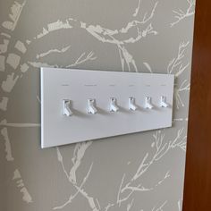 a white light switch sitting on top of a wall