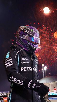 a person wearing a helmet standing in front of fireworks