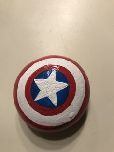 the captain's shield is painted red, white and blue with a star on it