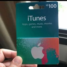 someone is holding up an apple itunes gift card for $ 100, which has been placed in their car