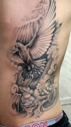 a man with a tattoo on his stomach that has a bird flying over the top