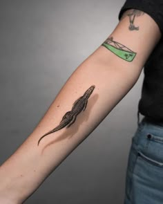 a person with a lizard tattoo on their arm