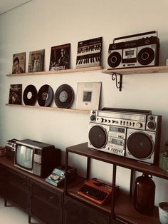 there are many old fashioned radio and stereos on the shelves