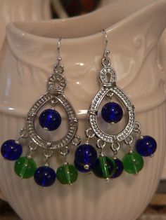 Chandelier earring cobalt blue and green glass by sallysbeadsnc Traditional Chandelier Earrings With Blue Dangling Beads, Bohemian Blue Adjustable Chandelier Earrings, Adjustable Blue Beaded Chandelier Earrings, Blue Chandelier Earrings With Colorful Round Beads, Blue Metal Bohemian Chandelier Earrings, Blue Nickel-free Dangle Chandelier Earrings, Cobalt Blue Earrings, Bold Earrings, Blue Earrings