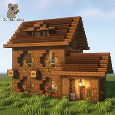 a small house made out of wood in the middle of some green grass and flowers