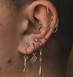 a man with ear piercings and chains on his ears