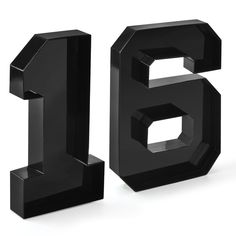 the number six is made out of black plastic and sits in front of a white background