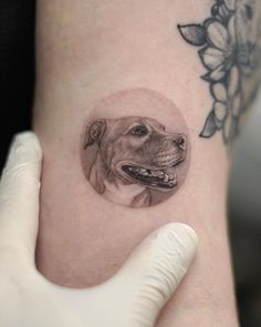 a dog's head is shown on the side of a woman's arm