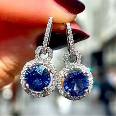 Rhinestones And Blue Round Sapphire Crystal Earrings. Almost .5” Diam. By .5” Length. New In Package Blue Halo Setting Earrings For Wedding, Blue Sapphire Earrings With Sparkling Stones, Blue Halo Design Earrings For Anniversary, Blue Round Earrings For Anniversary, Silver Sapphire Earrings For Party, Blue Cubic Zirconia Halo Earrings, Blue Crystal Round Jewelry, Blue Cubic Zirconia Earrings With Sparkling Stones, Blue Halo Design Earrings As Gift