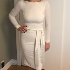 This Beautiful, Off-White Sheath Dress Is In Near Perfect Condition, And Was Only Worn Once On Wedding Day. Dress Has A Scoop Back And Sleeves Down To Wrist. Dress Hem Hits Just Above The Knee And Is 100% Polyester Size Medium. Has A Lot Of Stretch And Zipper Up The Back But Sits Very Fitted On Body. Pictures Make It Look Pure White, But It Is Off-White. Dress Has Been Dry Cleaned And Left In Dry Cleaning Bag, No Stains. - Hidden Back-Zip Closure - Bateau Neck - Long Sleeves - Attached Sash - Scoop Back - Back Slit - Lined 90% Polyester, 10% Spandex Specifications - Hidden Back-Zip Closure - Bateau Neck - Long Sleeves - Attached Sash - Scoop Back - Back Slit - Lined Pit To Pit Approx 17 Fitted Belted Dress For Brunch, White Fitted Mini Dress With Tie Waist, White Long Sleeve Bodycon Dress For Formal Occasions, White Long Sleeve Bodycon Dress For Formal Events, White Midi Length Dress With Tie Waist, White Long Sleeve Bodycon Dress For Work, White Midi Dress With Tie Waist, Elegant White Belted Dress For Formal Occasions, Fitted Midi Dress With Tie Waist For Cocktail Event