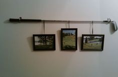 three framed pictures hanging on a wall