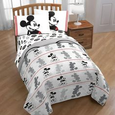 a mickey mouse bed in a bedroom