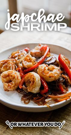 a white plate topped with shrimp and peppers