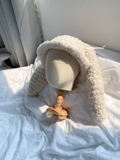 a white hat on top of a wooden dummy