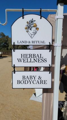 a sign that says land & ritual, herb and well - being baby and body care