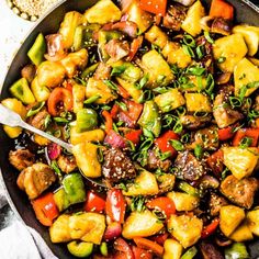 a skillet filled with vegetables and meat