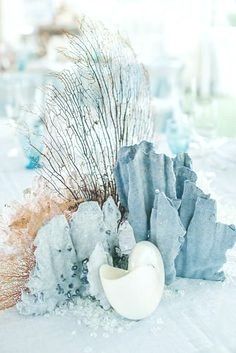 an egg shell is sitting in the middle of some corals on top of ice