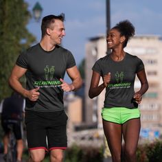 two people running in the street wearing matching t - shirts