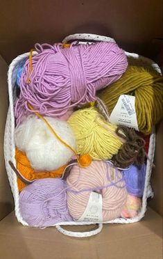 a box filled with lots of different colored yarn