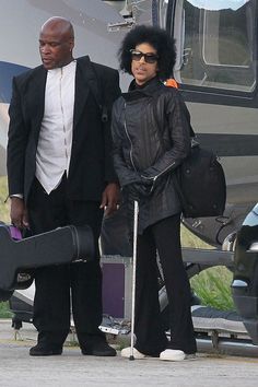 a man and woman are standing in front of an airplane with their suitcases on the tarmac