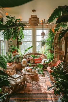 a living room filled with lots of green plants and wicker furniture in front of large windows