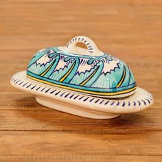 a blue and white ceramic dish sitting on top of a wooden table