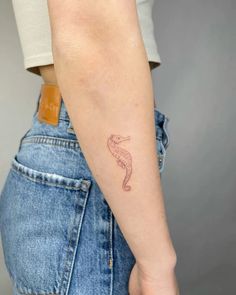 a woman's arm with a tattoo on it, showing the outline of a snake