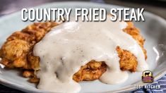 a white plate topped with fried chicken covered in gravy