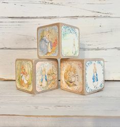 four wooden blocks with winnie the pooh images on them