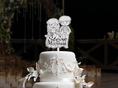 a three tiered white wedding cake with two people on top and the words sleeping miss written on it